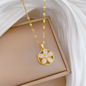 Detail of a rotating golden flower necklace with micro-pave crystals on a silk backdrop