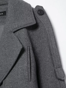 Detailed macro view of dark grey wool coat featuring notched lapels and black round buttons
