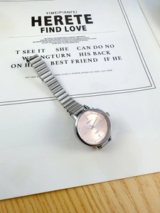 Detailed close-up of a Barsh silver metal chain watch with a pink quartz dial on card