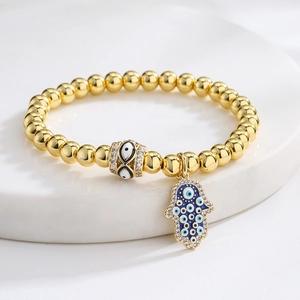 Golden Hamsa Hand and Evil Eye beaded bracelet with sparkling zircon and enamel detail