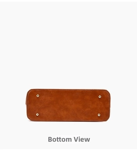 Detailed base view of brown leather bag showing four gold metal feet and stitching