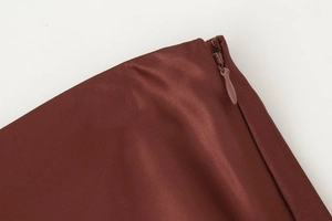Detailed view of the invisible zipper and texture on a satin finish contrast lace skirt