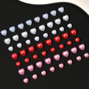 Mix of heart-shaped pearl beads in white, red, and pink for nail art and DIY decor