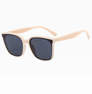 Detail of beige rectangular frame sunglasses with dark grey lenses on white background