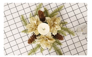 Golden Christmas wreath candle ring with faux pine needles and pinecones on a grid table