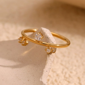 Detailed macro view of 18K gold plated ring featuring asymmetric white zircon settings