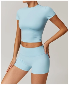Detail of light blue two-piece yoga set with high-waist shorts and cropped short sleeve top