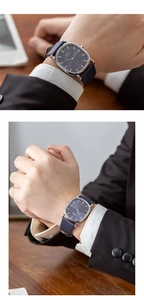 Close-up of slim silver square watch with blue dial and textured leather strap on wrist