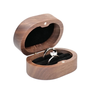 Detail of walnut wood double ring box with black velvet lining and magnetic closure