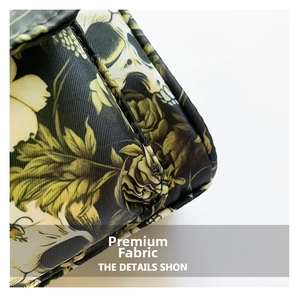 Macro shot of gothic floral fabric featuring skull and yellow rose patterns on a black bag