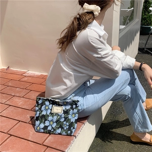 Close-up of vintage floral jacquard fabric on a blue flower pattern shoulder bag detail