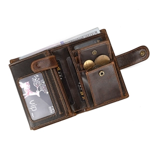 Detail of vintage brown leather wallet showing multiple card slots and snap coin pocket