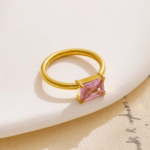 Detail of an 18K gold plated stainless steel ring with a pink rectangular zircon stone