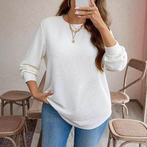 Detail of waffle knit texture on this cream long sleeve top with ribbed crew neck design