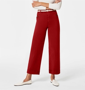 Detail of red wide-leg trousers featuring a white belt and premium waist stitching