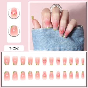 Pink gradient press-on nails with green French tips and cute peach nail art patterns