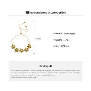 Detail of adjustable gold bracelet featuring five vibrant green zircon flower charms