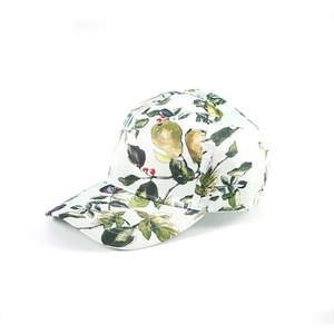 Detail showing the green leaf and yellow pear print on the white baseball cap