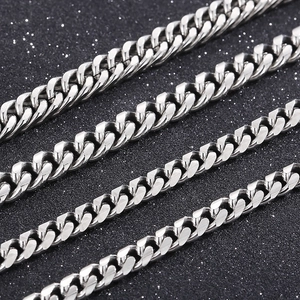 Macro detail of silver stainless steel Cuban link chains with polished round edges