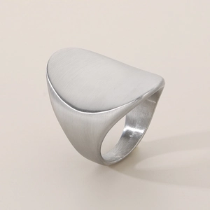 Detail of silver brushed titanium steel wide oval ring showing fine metal texture