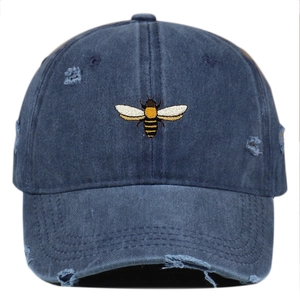 Distressed navy denim baseball cap with bee embroidery and vintage worn-out details
