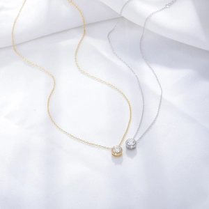 S925 sterling silver round zircon necklaces in gold and silver finish on silk background
