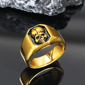 Detailed macro view of punk style gold skull ring with vintage black metal textures