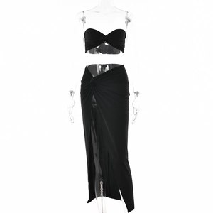 Women's black two-piece set featuring a ruched tube top and high-slit maxi skirt