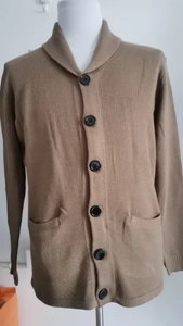 Detail of men's shawl collar knit cardigan with front buttons and pockets in tan brown