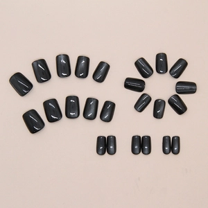 Macro shot of 24pcs deep gray magnetic cat-eye press-on nails with silver glitter shimmer