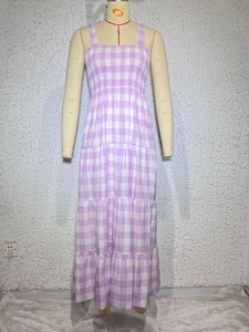 Detail of purple gingham tiered dress featuring smocked chest and delicate thin straps