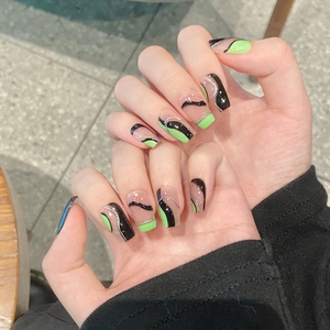 Short square press-on nails with fluorescent green and black wavy minimalist designs