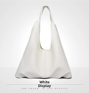 Macro shot of white pebble grain leather and seamless shoulder strap on the hobo tote bag
