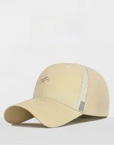 Detailed embroidery of letter N on a beige breathable mesh running baseball cap