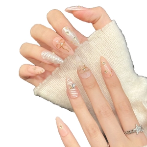 Handmade pink press-on nails with 3D gold bowknots, pearls and sparkling rhinestones
