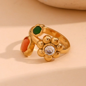 Macro shot of 18K gold plated ring with emerald green and orange flower shaped crystals