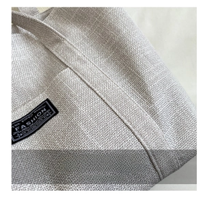 Close-up of double stitching and woven canvas texture on a minimalist tote bag detail