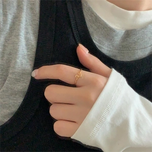 Close-up of minimalist gold heart ring worn on finger for a stylish lifestyle look