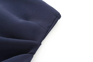 Macro shot of navy blue woven twill fabric showing detailed texture and stitching