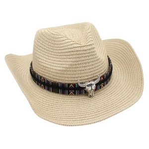 Detail of western straw cowboy hat featuring ethnic ribbon and silver bull skull ornament
