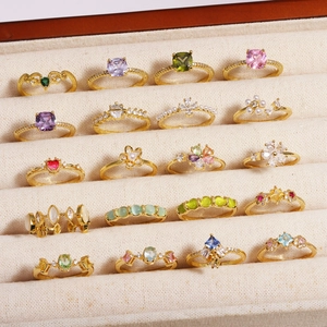 Elegant gold-plated flower rings with colorful zircon stones and pearls in a jewelry box