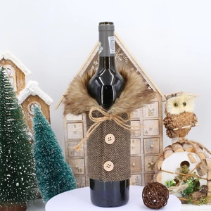 Detailed view of herringbone fabric wine bottle cover with faux fur collar and wood buttons
