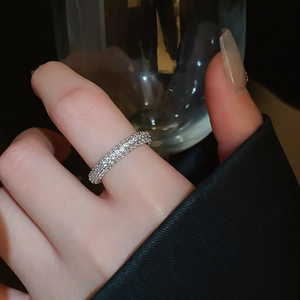 Macro detail of three-row pavé twisted silver ring with sparkling cubic zirconia stones