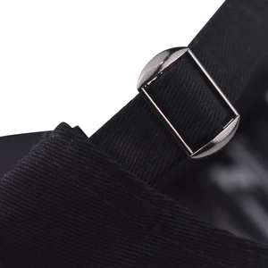 Detail of vintage baseball cap featuring adjustable silver metal buckle on black cotton fabric