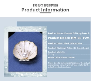 Detail view of pearl enamel shell brooch in white alloy with dimensions of 33mm by 38mm