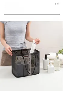 Detail of black mesh bath storage bag with handles and Bath Storage text on grey ribbon