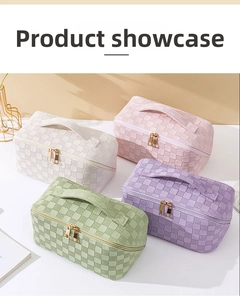 Detail of checkered makeup bags with top handles and golden zippers in soft pastel colors