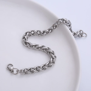 Classic 7mm stainless steel men's curb chain bracelet with lobster clasp on white ceramic