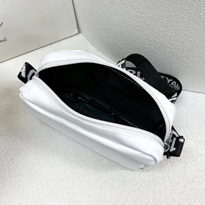 Minimalist white nylon crossbody bag with wide lettered strap and black lining