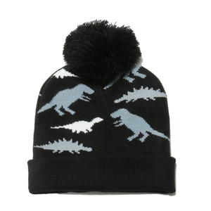 Kids black knit winter hat featuring blue dinosaur jacquard pattern and fluffy pompom top